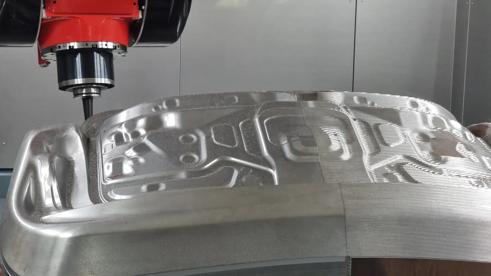 5-axis machining center cutting a large sculpted aluminum aerospace panel